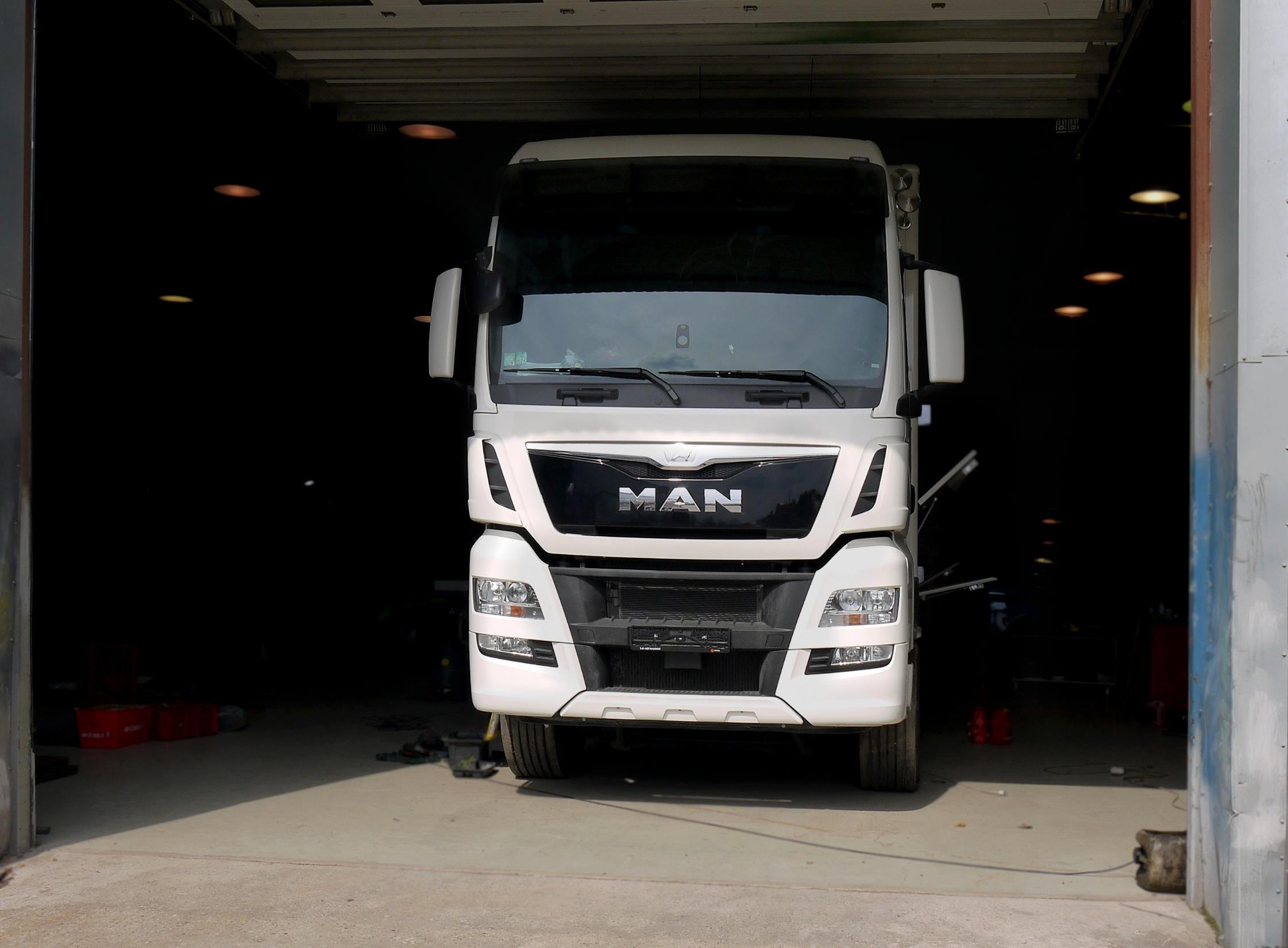 MAN TGX transporter front view inside the workshop