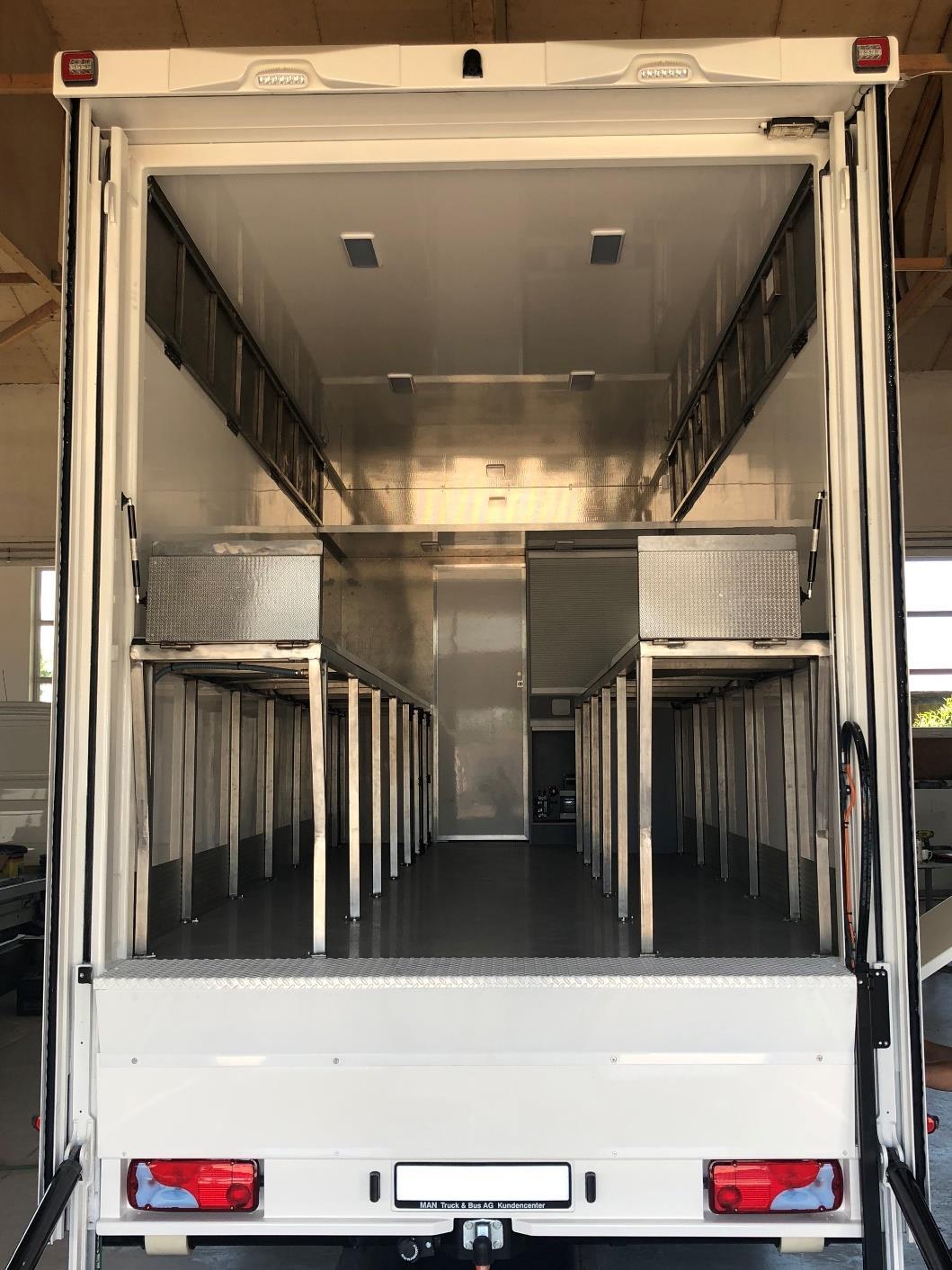 Open cargo bay with racking inside the MAN TGS transporter