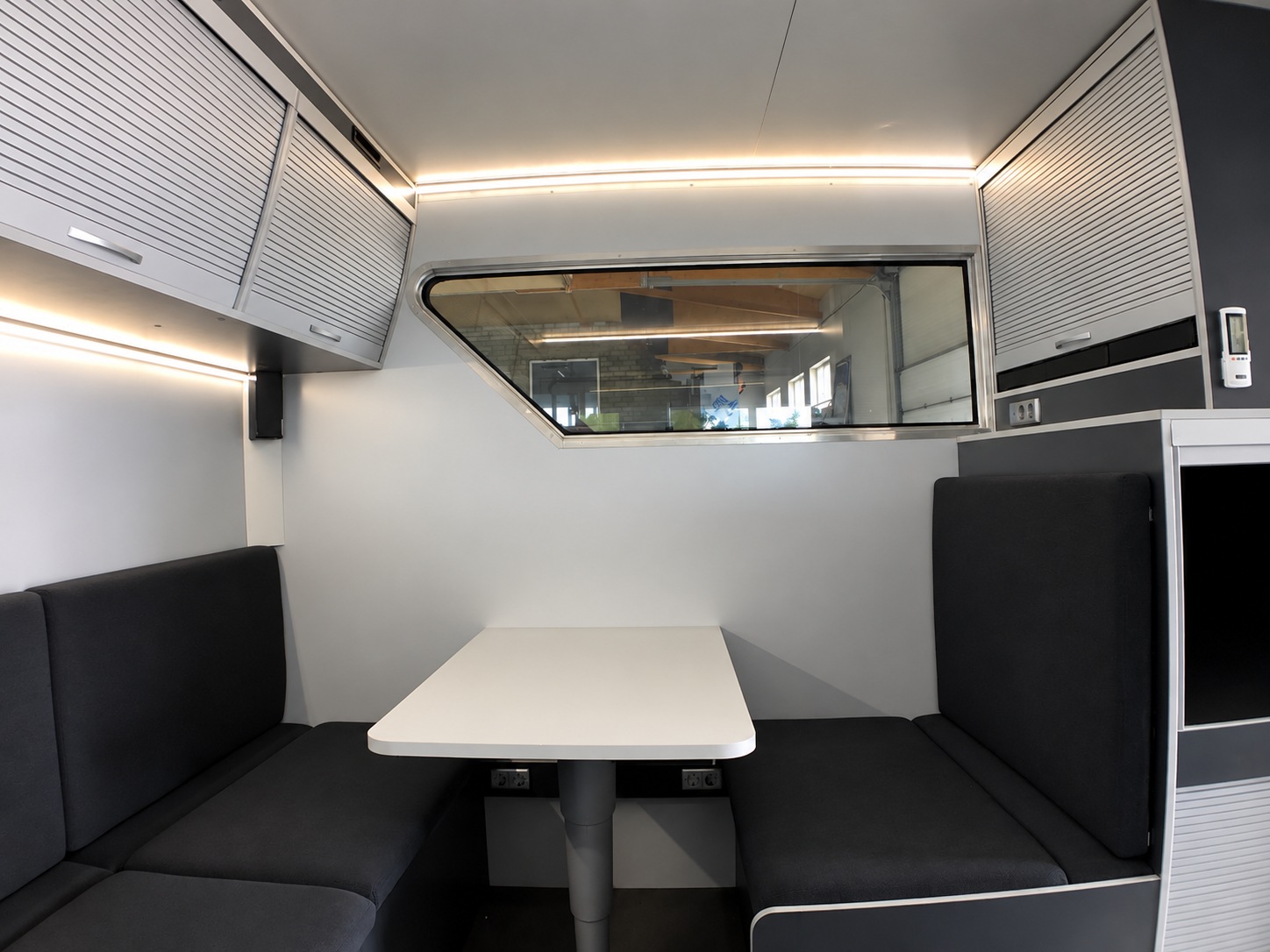 Lounge seating and table inside the DAF XF transporter