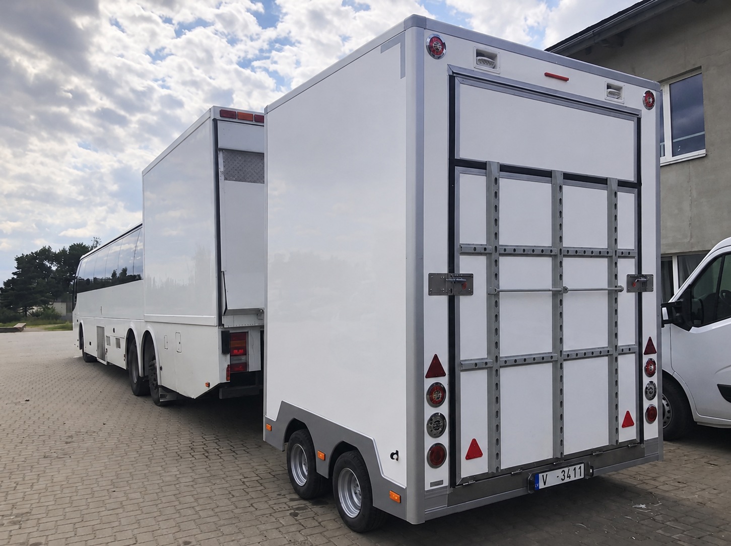 Rear view of the bus, garage box and service trailer