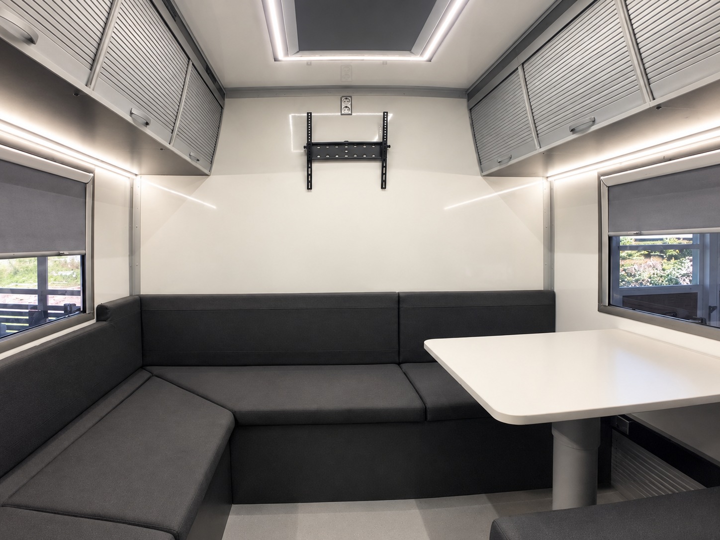 Lounge seating and table inside the bus